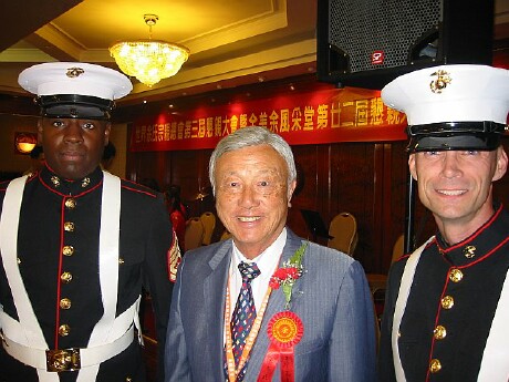 Dr Herbert Yee flanked by US Marine Corps Color Guard